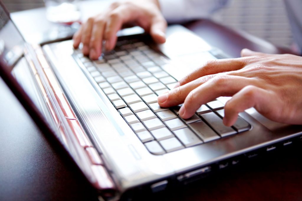 Someone searching for more information about mental health using their laptop