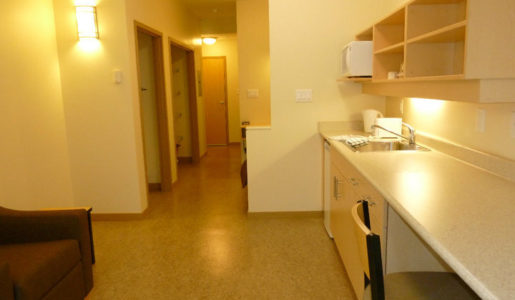 CMHA Kelowna Supportive housing Interior picture of one of CMHA Kelowna's many supportive housing units. A clean kitchen and living room as well as a room and a bathroom. Well lit and furnished