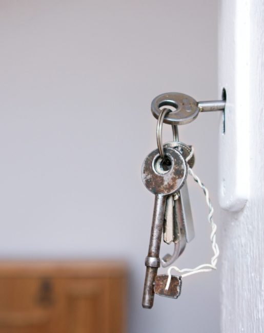Unlocking your future Keys handing from a door lock symbolizing "Building homes", a core value of CMHA Kelowna