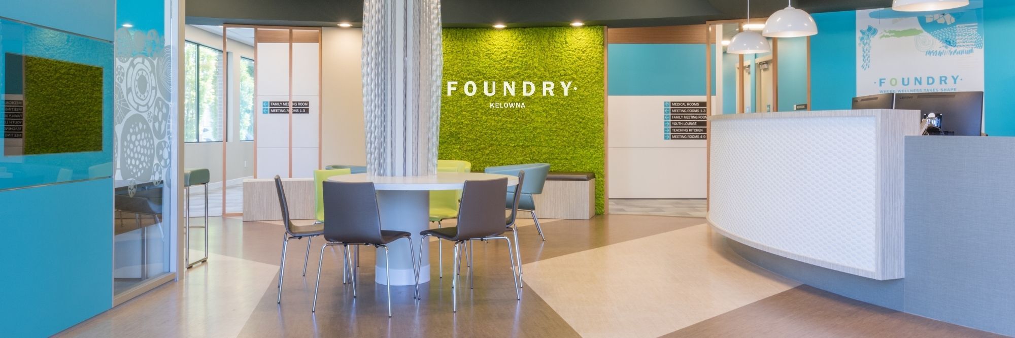Inside the front doors of foundry Kelowna, a lovely and calming office with baby blue and light green colouring