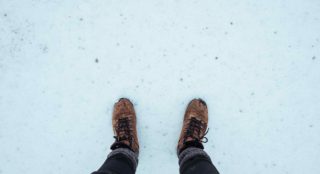 winter blues legs and brown winter shoes standing in the snow